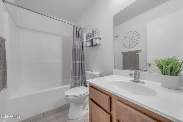 a en suite bathroom with a tub sink and mirror