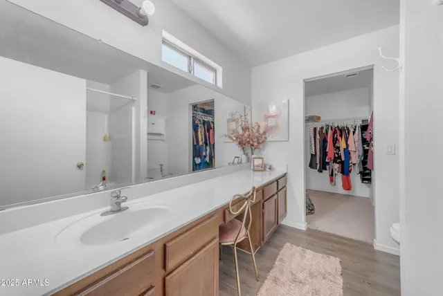 a view of a livingroom with furniture and chandelier fan