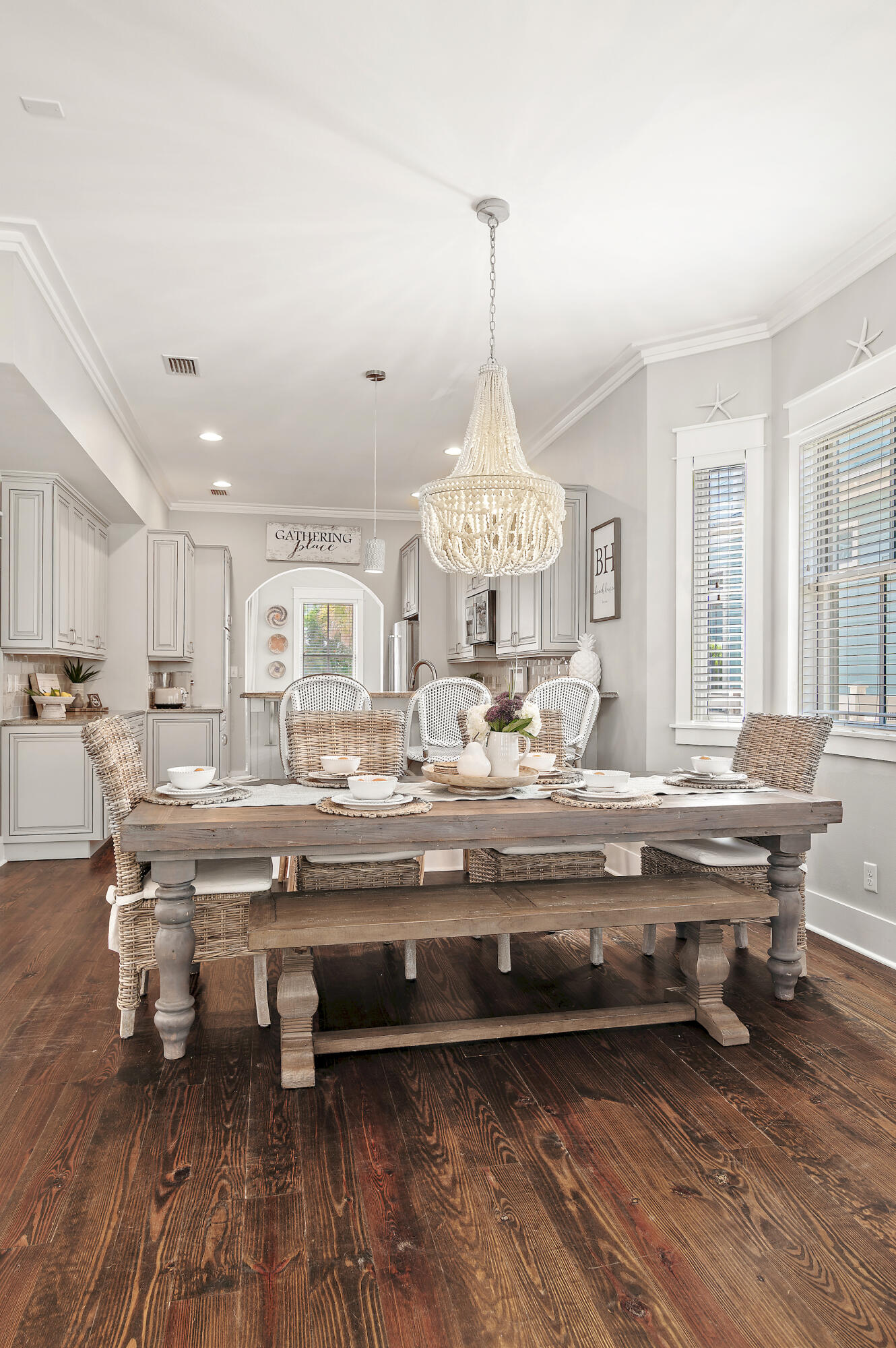 624 Sandgrass Boulevard Santa Rosa Beach, FL 32459 - Photo 13 of 51 a view of dining room and kitchen with a table chairs and wooden floor