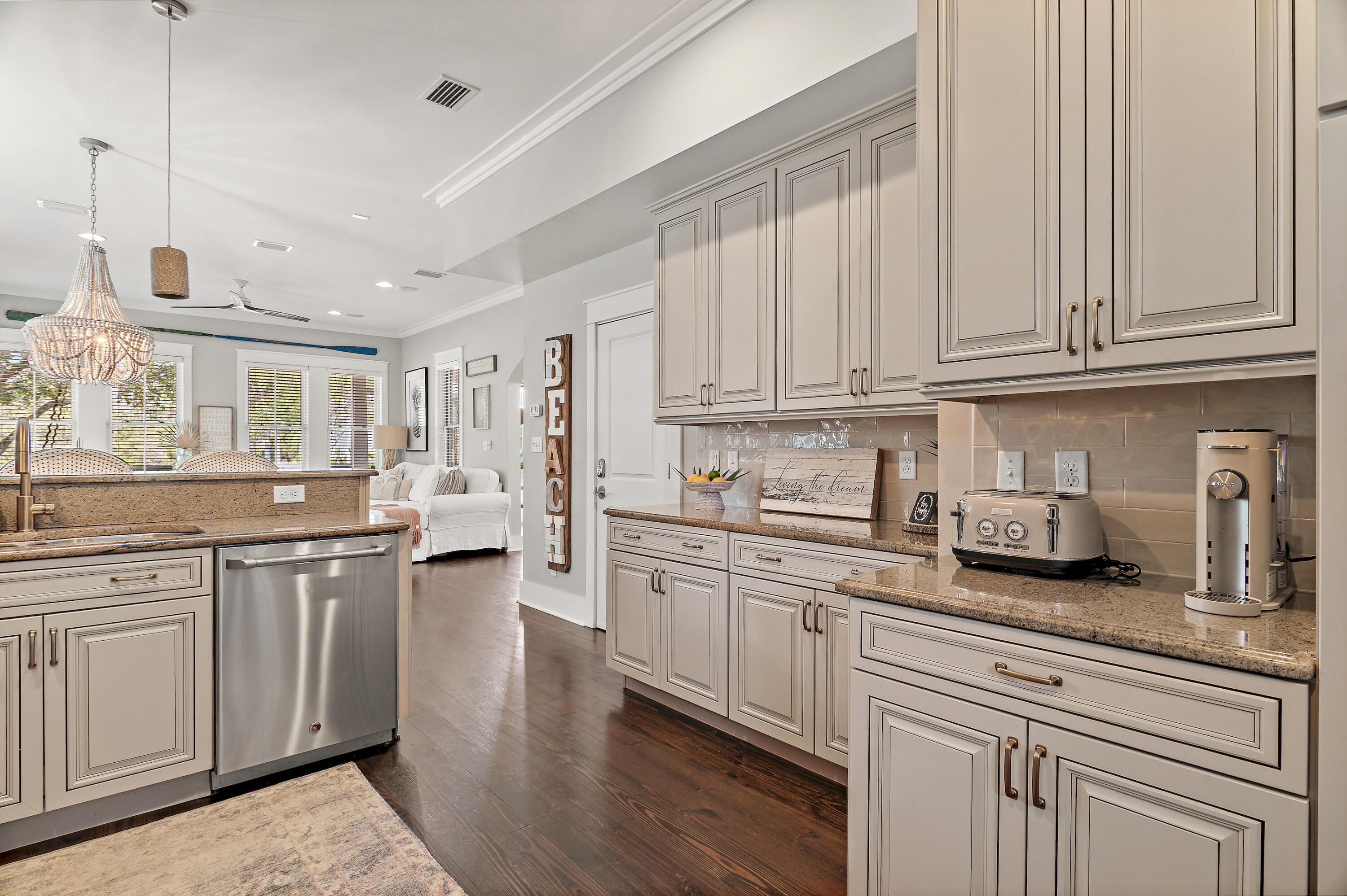 624 Sandgrass Boulevard Santa Rosa Beach, FL 32459 - Photo 16 of 51 a kitchen with stainless steel appliances granite countertop a sink and cabinets with wooden floor
