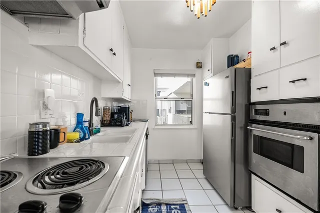 a kitchen with a stove and a refrigerator