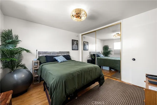 a bedroom with a bed and potted plant