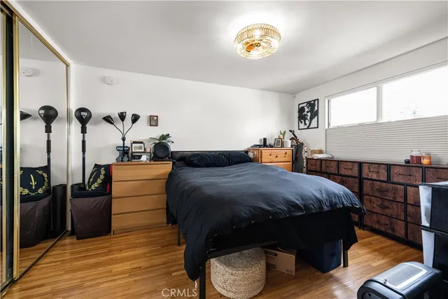a bedroom with a bed and wooden floor