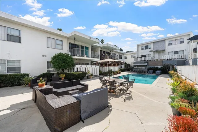 a building outdoor space with patio furniture and potted plants