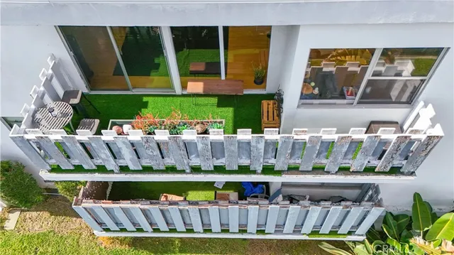 a view of swimming pool with lawn chairs potted plants
