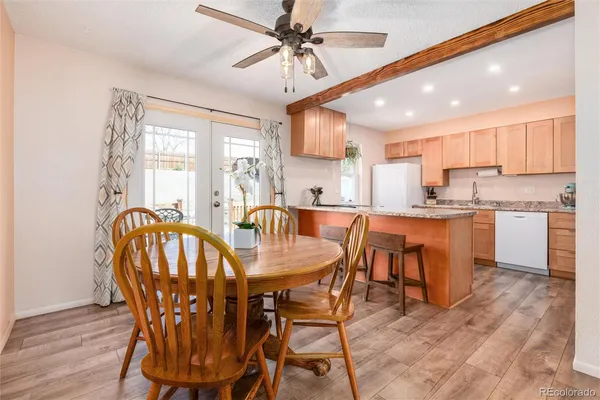 a view of a dining room with furniture and wooden floor