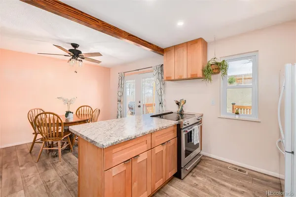 a kitchen with stainless steel appliances granite countertop a stove a sink and a refrigerator