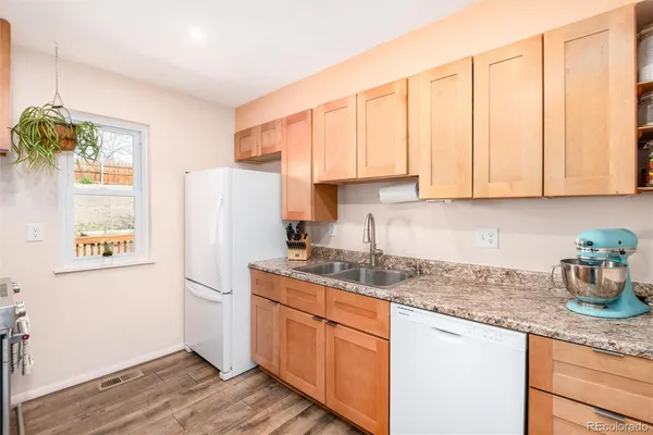 a kitchen with stainless steel appliances granite countertop a refrigerator sink and cabinets