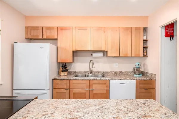 a kitchen with a sink stove and refrigerator