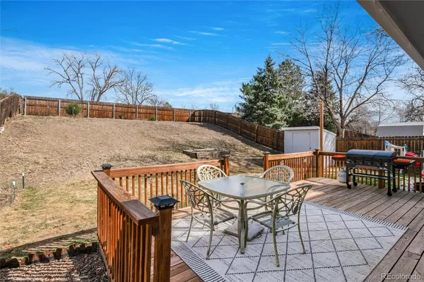 a view of a patio with a table and chairs