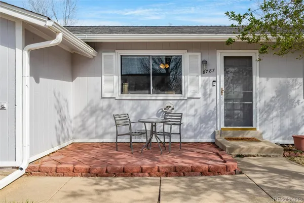a front view of a house with outdoor seating