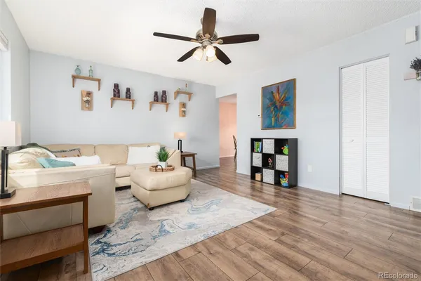 a living room with furniture and kitchen view