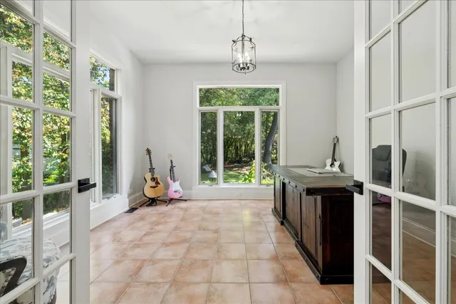 a bedroom with a bed wooden floor and flat screen tv