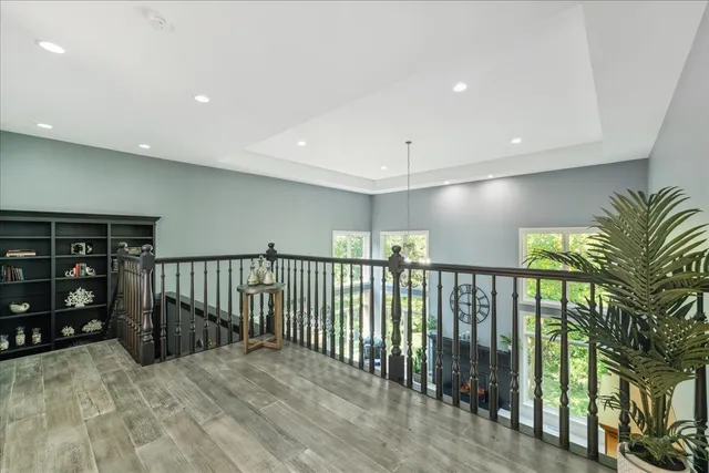 a spacious bathroom with a granite countertop sink a toilet a shower and a mirror