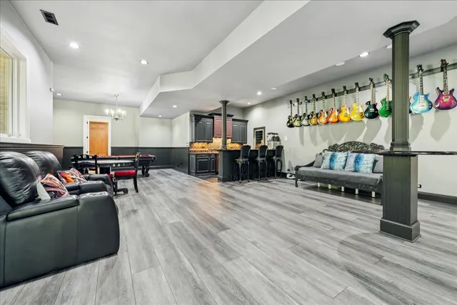 a view of a balcony with chairs and wooden umbrella