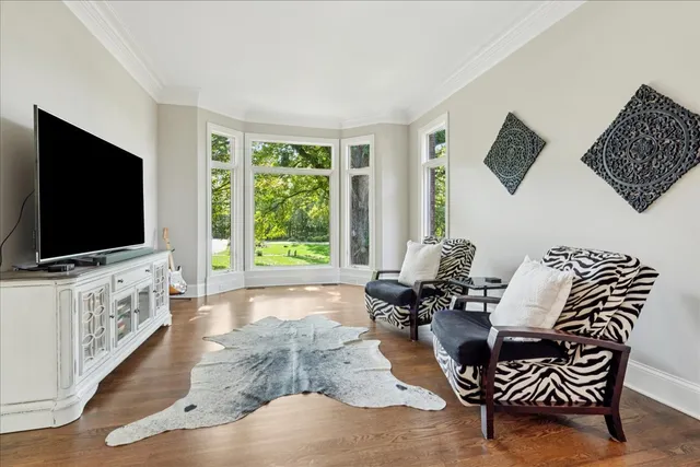 a view of a dining room with furniture wooden floor and chandelier