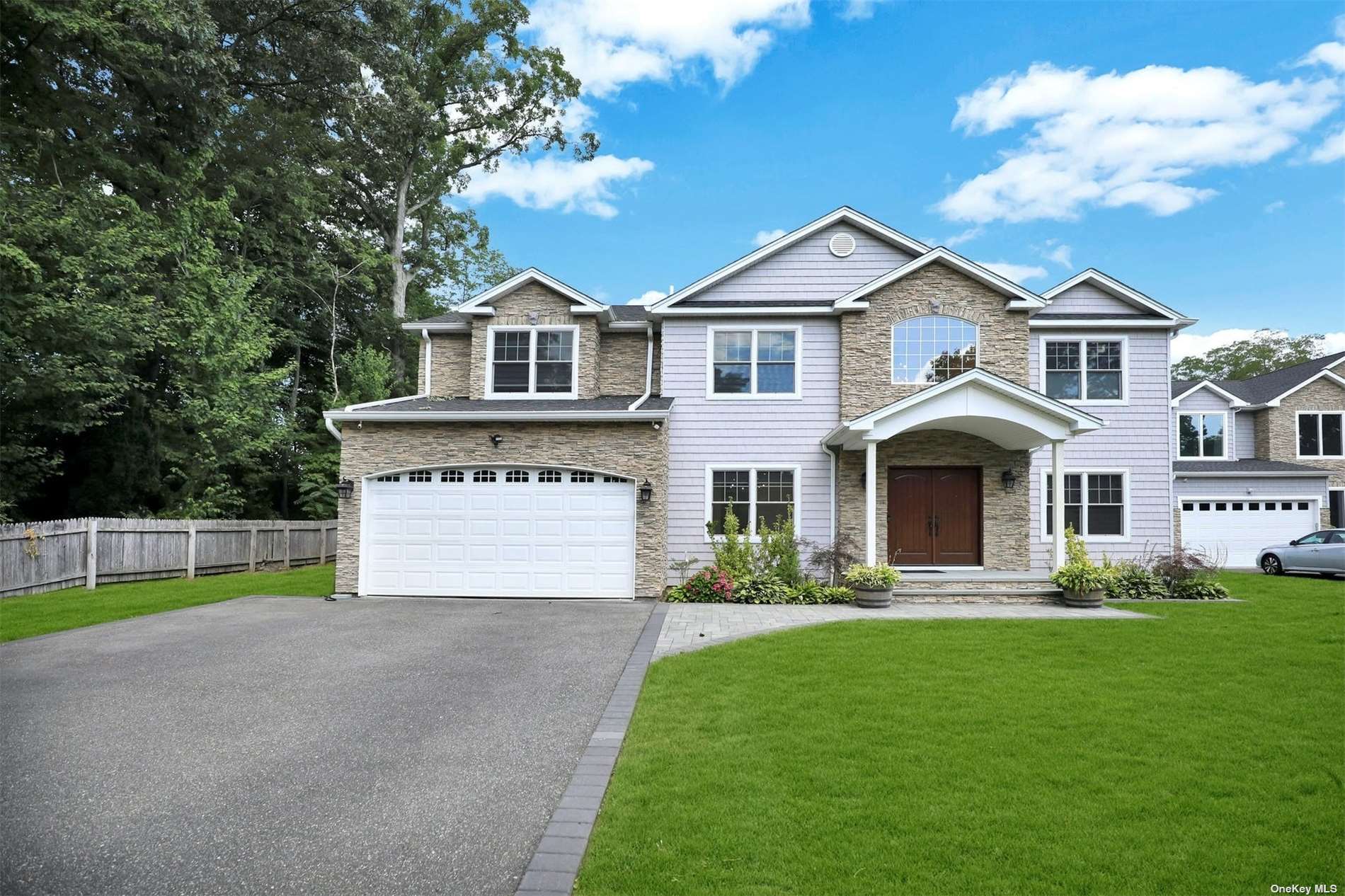 10 Cedar Street Syosset, NY 11791 - Photo 1 of 1 a front view of a house with a yard and garage