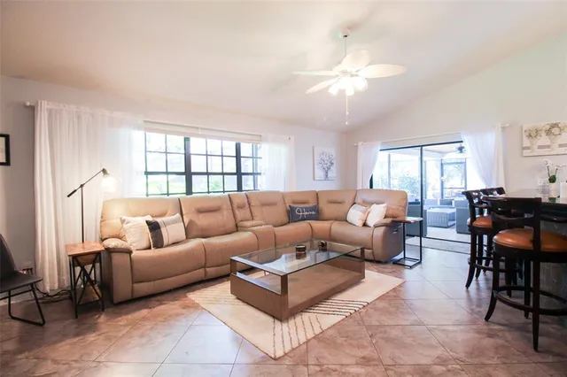 a kitchen with stainless steel appliances granite countertop white cabinets sink and a microwave