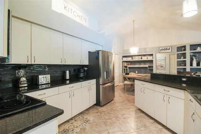 a kitchen with stainless steel appliances granite countertop a stove and a microwave