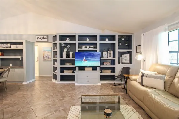 a living room with furniture cabinets and window