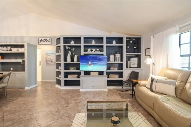 a living room with furniture cabinets and window
