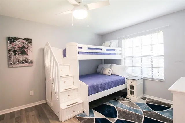a view of a hallway with wooden floor and closet