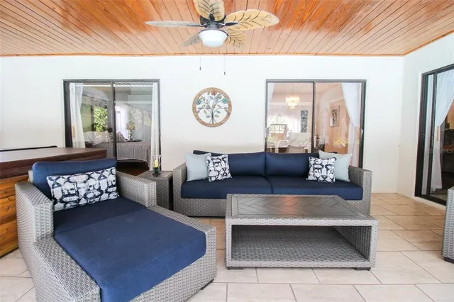 a living room with furniture and a floor to ceiling window