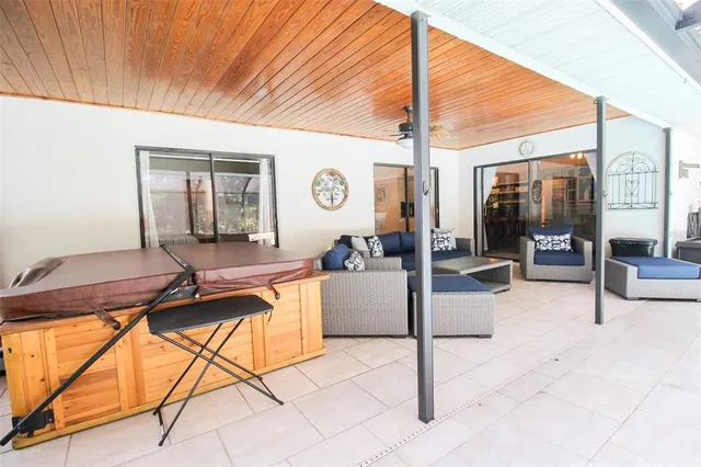 a view of a swimming pool with a yard and sitting area