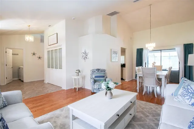 a room with stainless steel appliances kitchen island granite countertop furniture and a view of living room