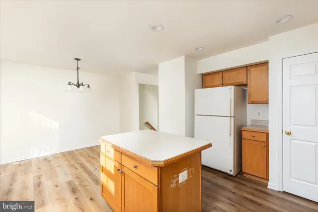 a view of kitchen with stainless steel appliances cabinets and wooden floor