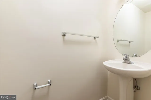 a bathroom with a sink a mirror and a toilet