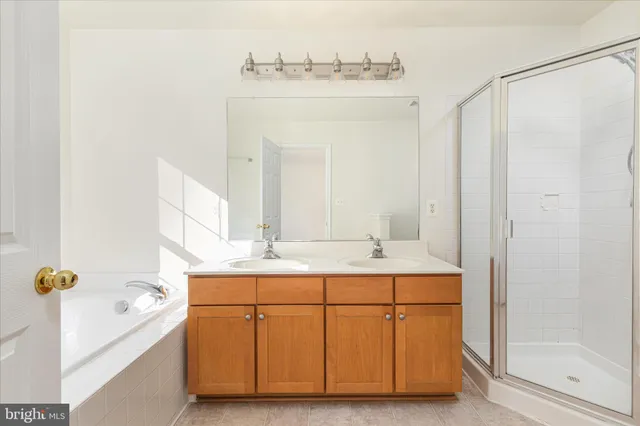 a bathroom with a tub sink and mirror