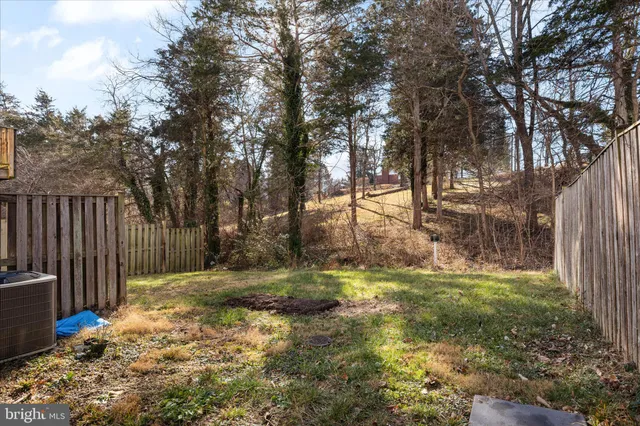 a view of a house with brick walls and a yard