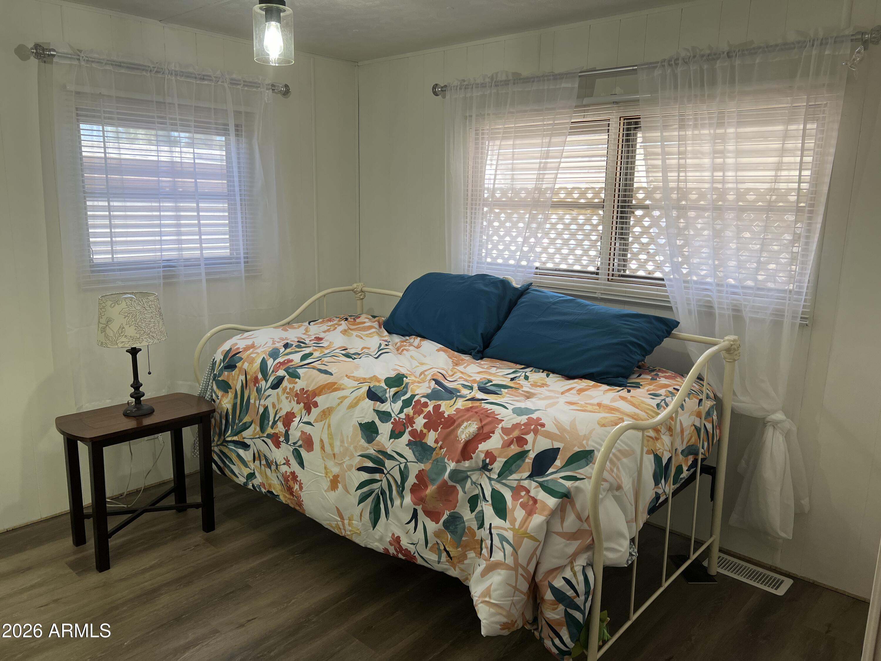19225 North Cave Creek Road, Unit 40 Phoenix, AZ 85024 - Photo 4 of 21 a bedroom with a bed a window and a mirror