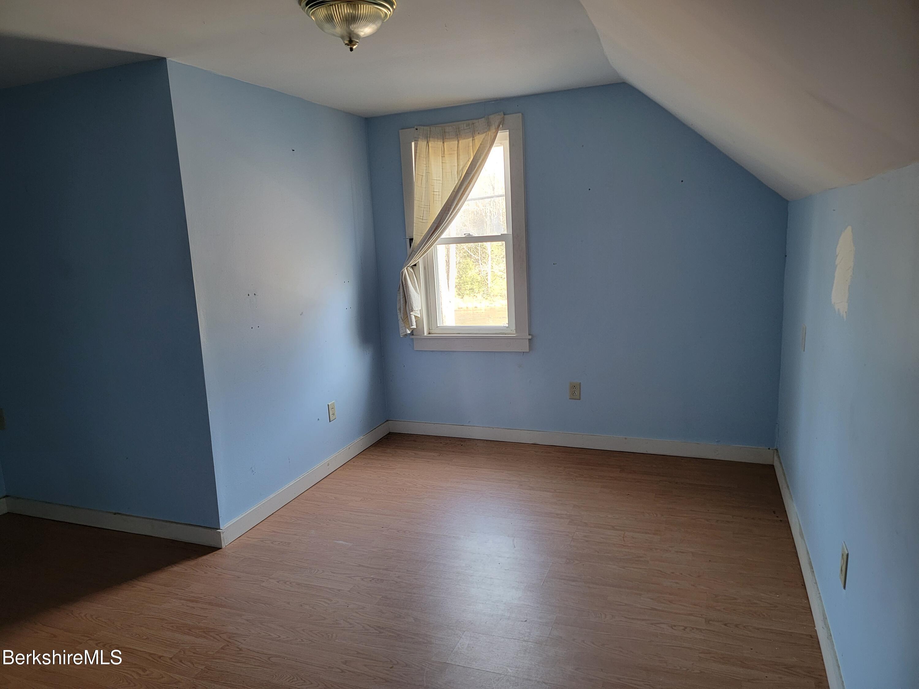 249 River Road Florida, MA 01367 - Photo 28 of 35 an empty room with wooden floor and windows