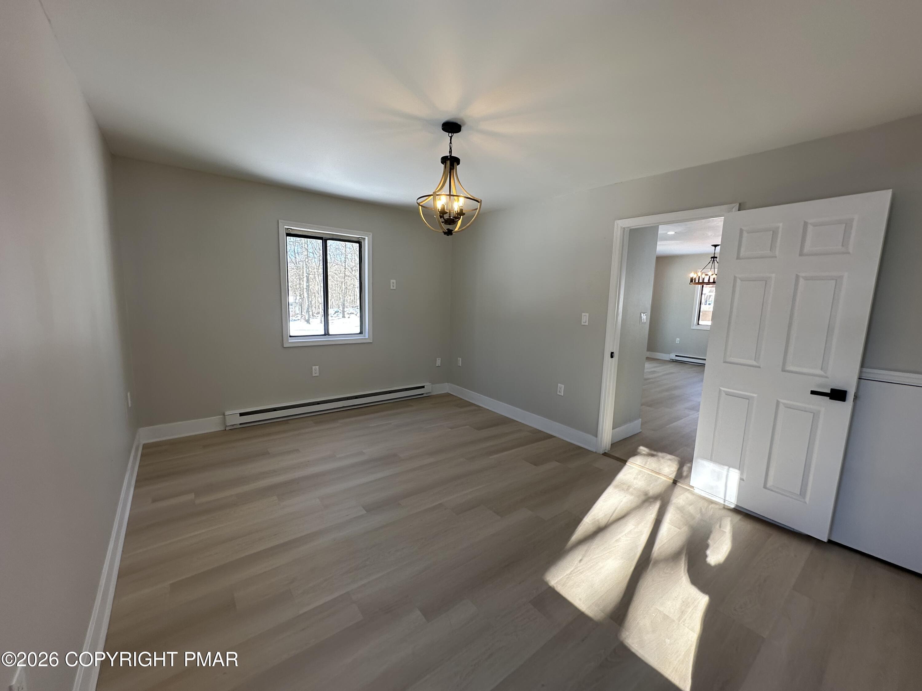 147 Pocono Boulevard Bushkill, PA 18324 - Photo 16 of 28 wooden floor in an empty room with a window