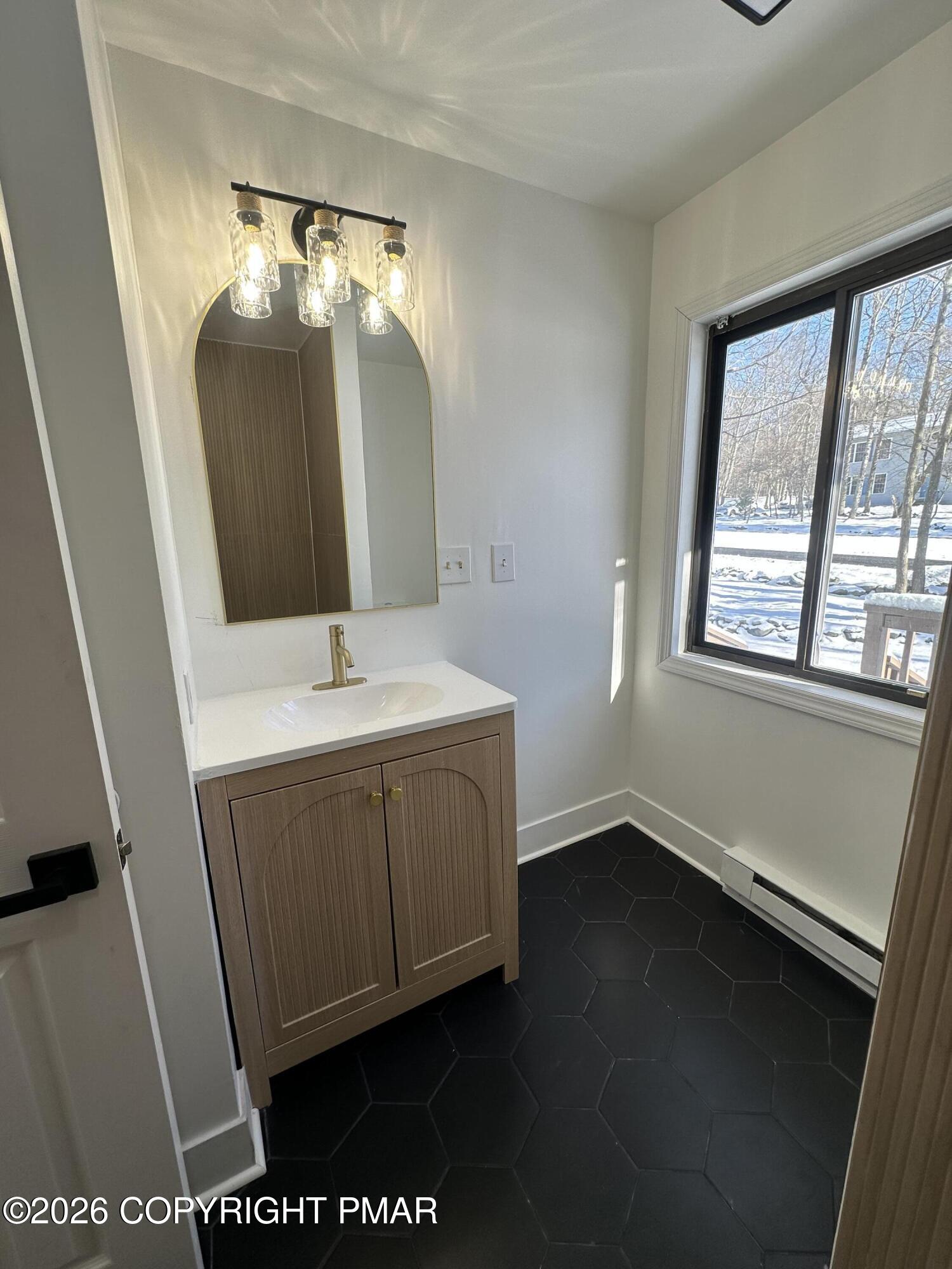 147 Pocono Boulevard Bushkill, PA 18324 - Photo 19 of 28 a bathroom with a sink a vanity and a mirror