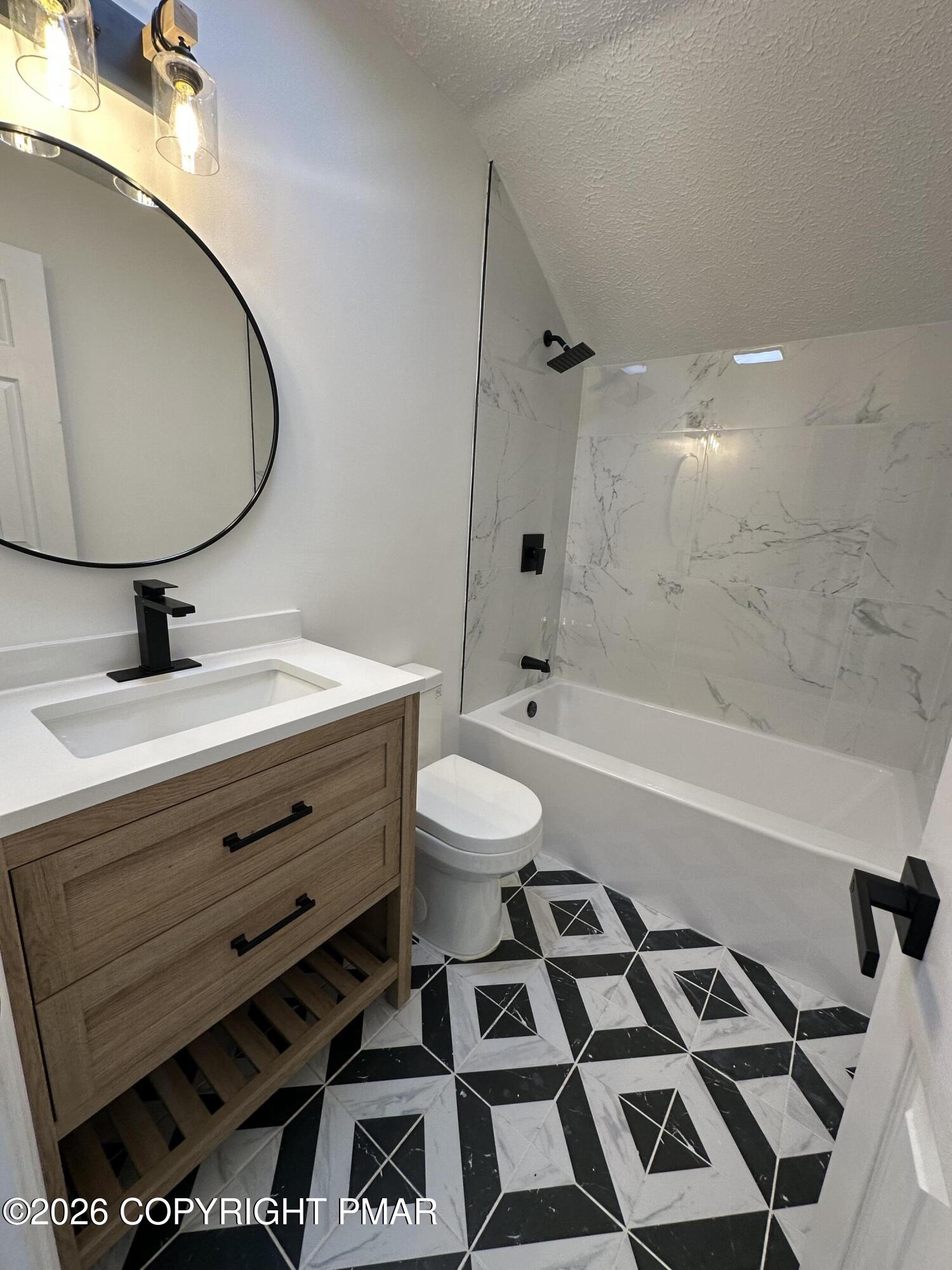 147 Pocono Boulevard Bushkill, PA 18324 - Photo 23 of 28 a bathroom with a sink a toilet and a mirror