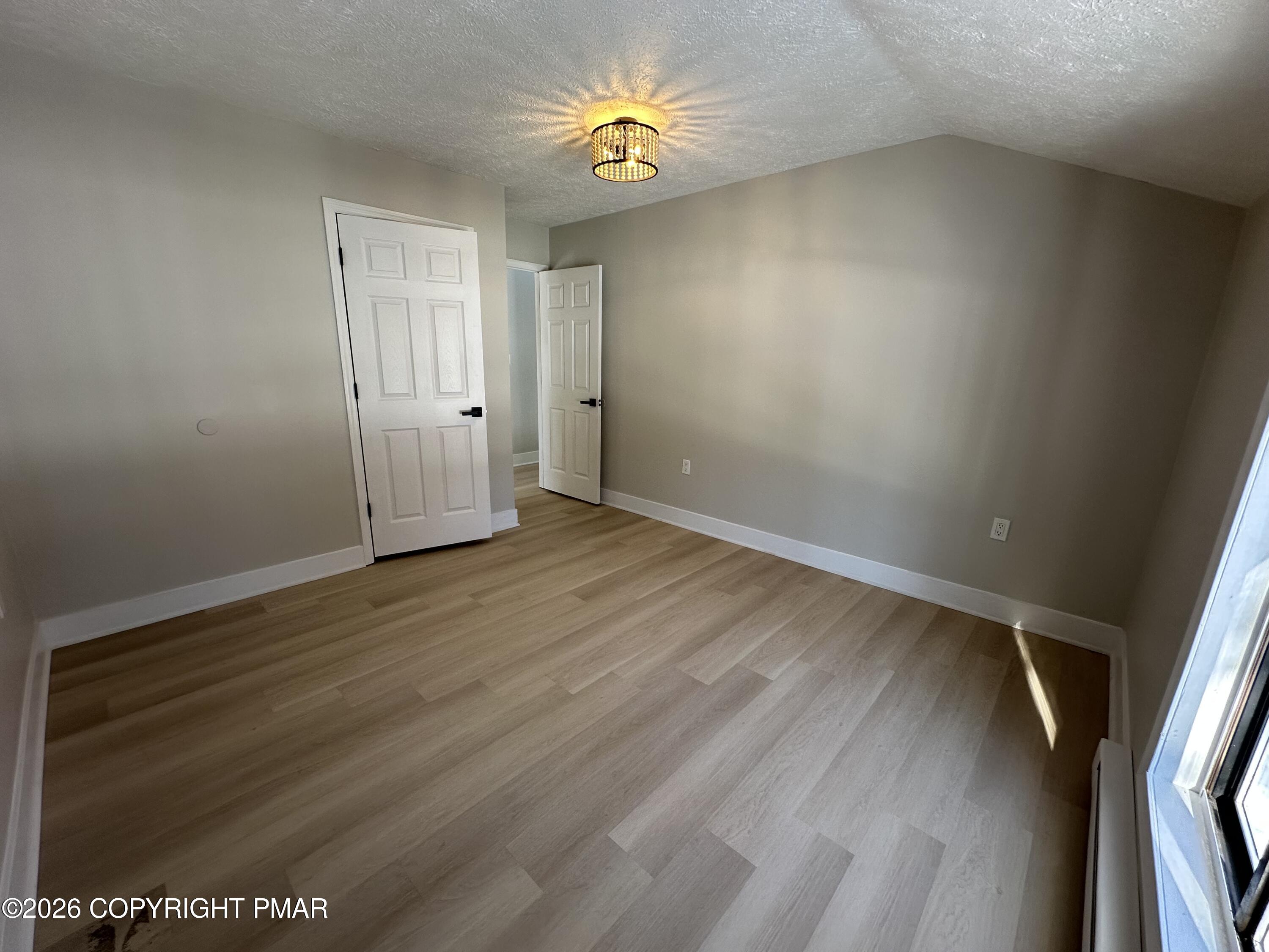 147 Pocono Boulevard Bushkill, PA 18324 - Photo 26 of 28 wooden floor in an empty room with a window