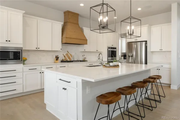 a kitchen with stainless steel appliances a sink stove and cabinets