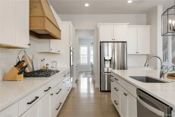 a kitchen with stainless steel appliances a sink stove and refrigerator