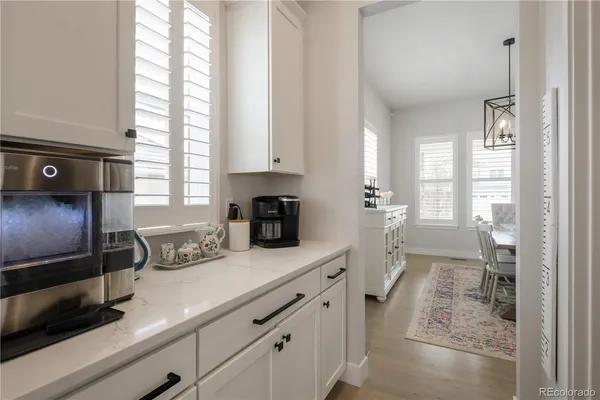 a kitchen with stainless steel appliances sink a refrigerator and window