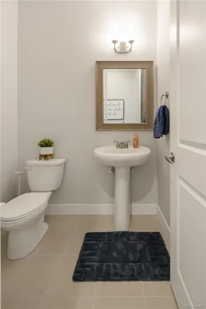 a bathroom with a sink toilet and mirror