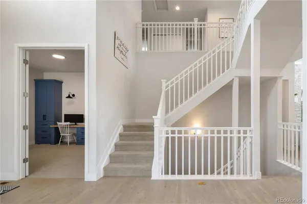 a view of staircase with white walls and a window