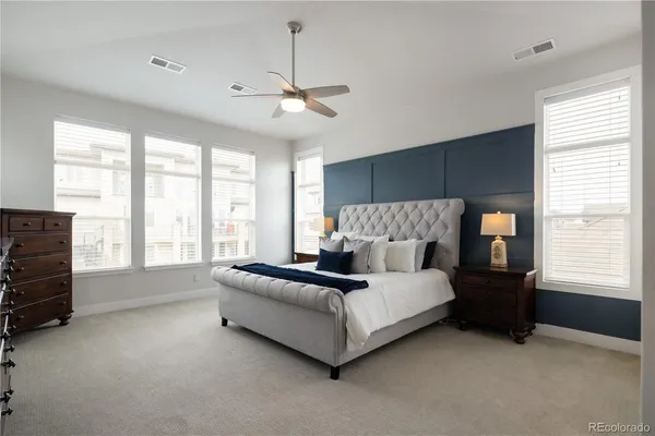 a spacious bedroom with a bed and a window