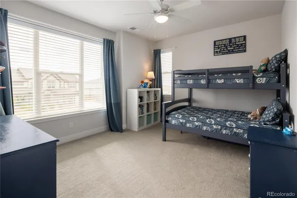a bedroom with bed and a large window