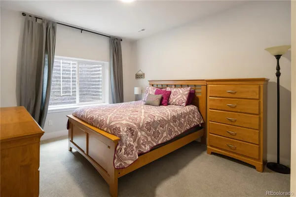 a bed sitting in a bedroom next to a window