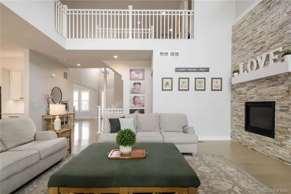 a living room with furniture wooden floor and a fireplace