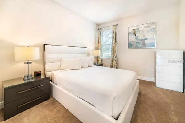 a bedroom with a bed and a night stand