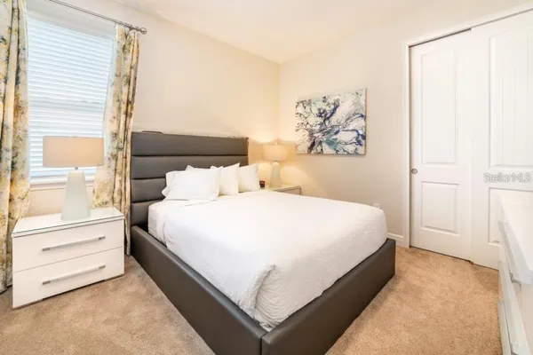 a bed room with a bed and a night stand